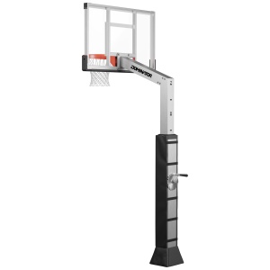 Adjustable outdoor basketball hoop system with a transparent backboard labeled "dominator," mounted on a sturdy black pole with a crank handle for height adjustment.