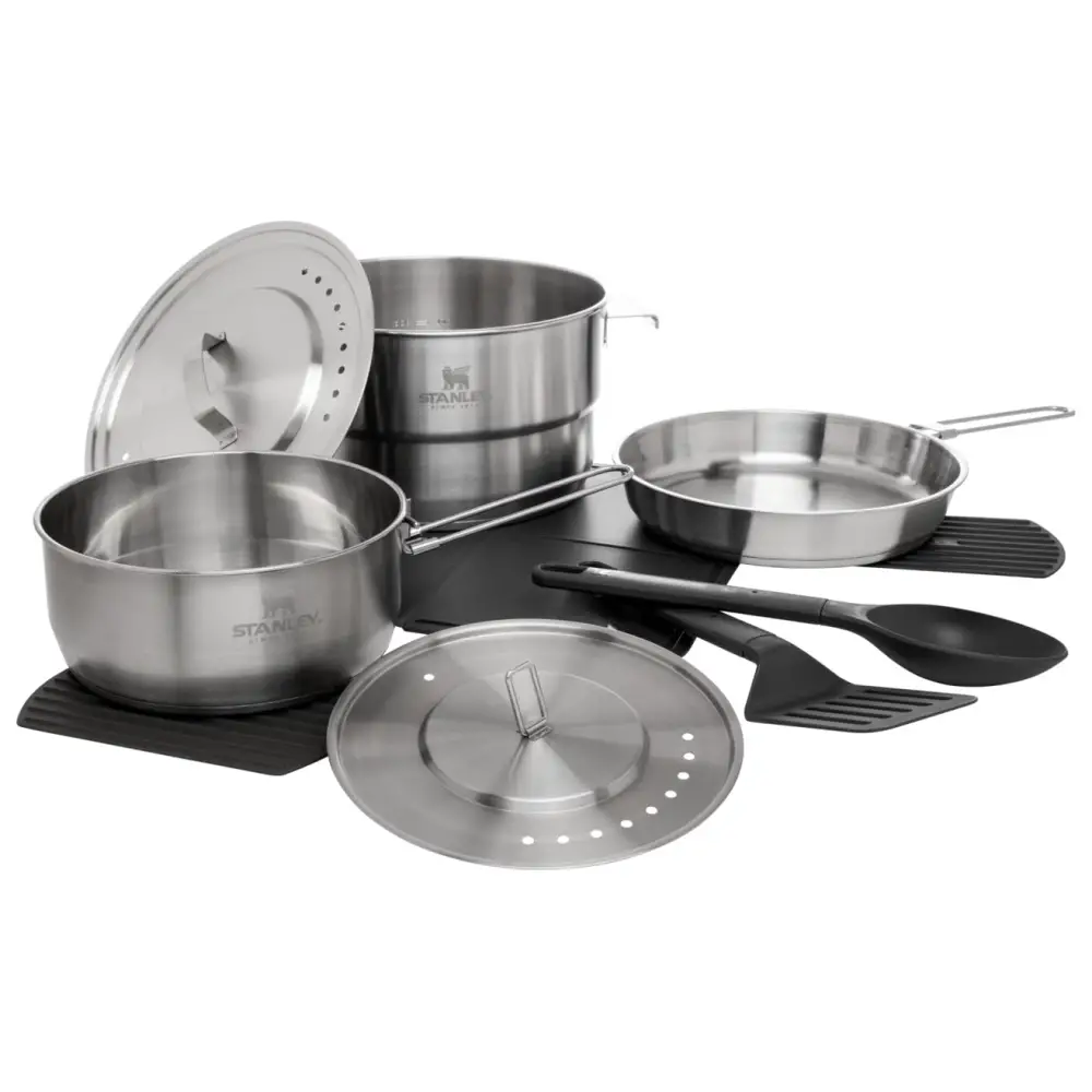 Set of stainless steel cookware including pots, pans, lids, and utensils.
