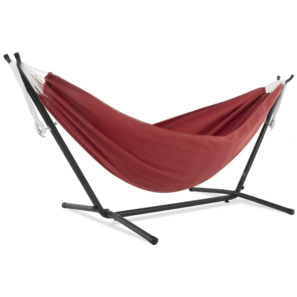 Red fabric hammock with a black metal stand isolated on a white background.