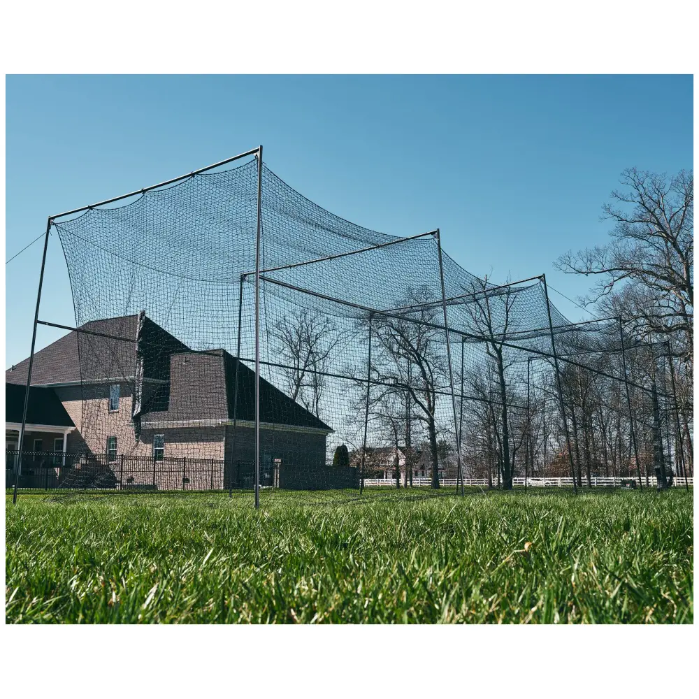 Baseball field backstop with protective netting on a clear day.
