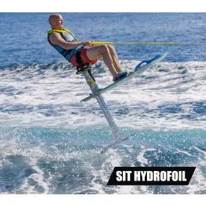 A man using an Air Chair ZUP Board with Seat & Full Hydrofoil Assembly glides above the water, tethered by a rope, against a clear blue ocean background.