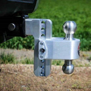 Close-up view of a Weigh Safe Aluminum 180° Adjustable Drop Hitch attached to the back of a vehicle, featuring an aluminum 180° dual-ball setup and multiple height settings.