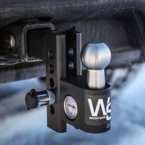 A Weigh Safe Steel Aero Adjustable Drop Hitch with a built-in scale is attached to a vehicle's receiver. The scale indicates the trailer's tongue weight for safe towing. This adjustable drop hitch ensures you can adapt to various towing needs with ease and precision.