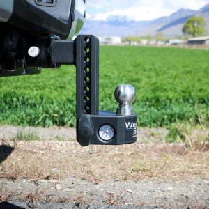 A Weigh Safe Steel Adjustable Drop Hitch installed on the back of a vehicle, designed to assist in even weight distribution while towing, can be complemented with a Weigh Safe Steel Adjustable Drop Hitch for enhanced stability and precision.