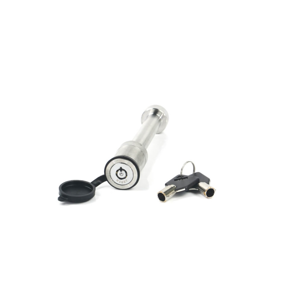 A cylindrical metal lock with a black rubber cap and two matching keys placed beside it, perfect for securing your Weigh Safe Steel Weight Distribution Adjustable Drop Hitch or ensuring the safety of your Weigh Safe system.