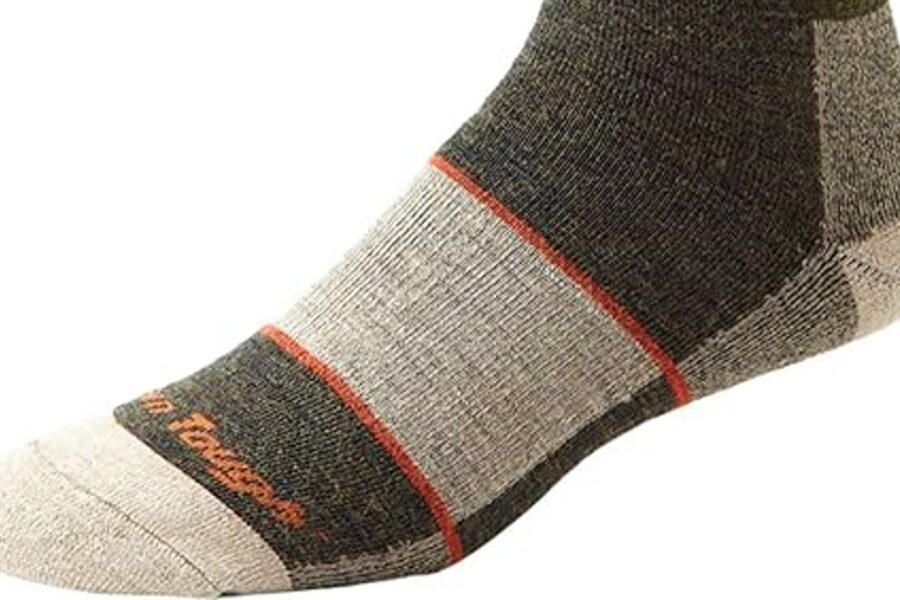 A close-up of a person's foot wearing a gray and dark green sock with orange accents and the "Dry Fusion" logo on the toe, perfect for keeping toasty feet during ice fishing.